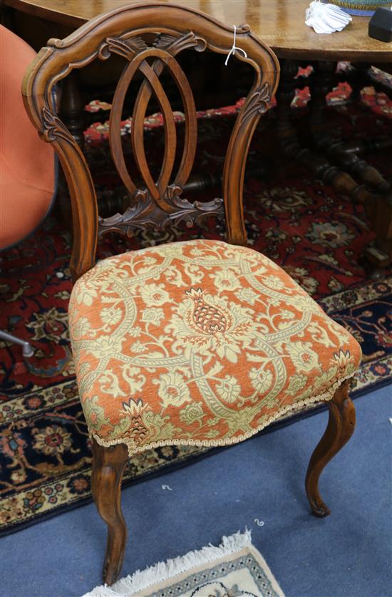 A set of six Victorian carved walnut dining chairs with pierced backs and cabriole legs